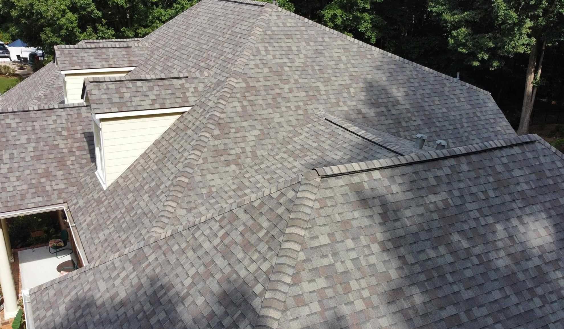 house exteriors roof close up with repaired asphalt shingles roofing